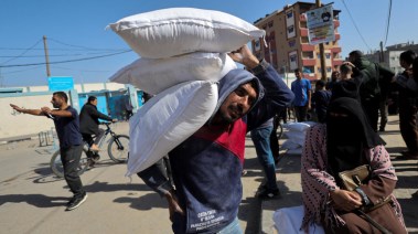 غزاويون يحملون المساعدات في غزة - أرشيفية