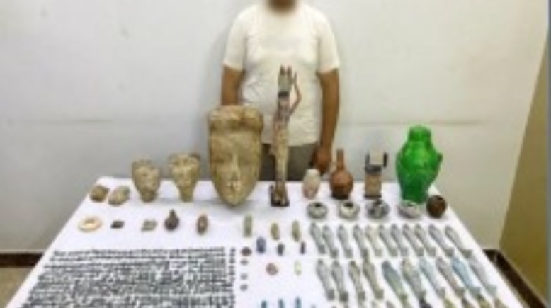 المتهم وبحوزته المضبوطات الأثرية