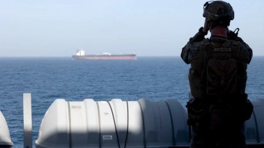 جندي من مشاة البحرية الأمريكية يراقب حركة الملاحة البحرية خلال عمليات الحصار البحري في مضيق هرمز