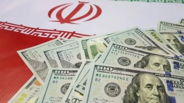 دولارات فوق علم إيران - تعبيرية 