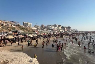 شاطئ البحر يمتلئ بسكان غزة هربًا من الحر
