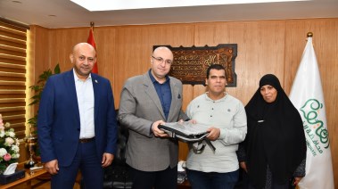لقطة أثناء تسليم الطالب اللاب توب 